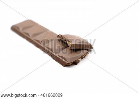 Cracked Chocolate Bar With A Composition Of Chocolate And Cashew Isolated On A White Background.