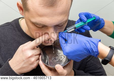A Nurse Rinses The Nasal Cavity Of A Patient
