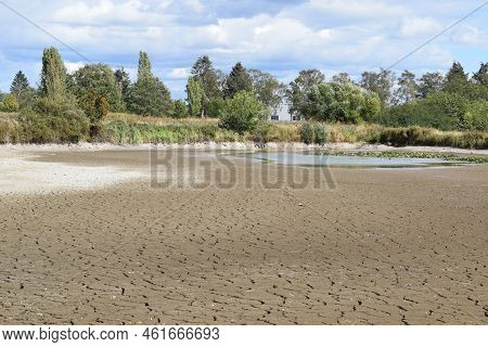 Swamp Lake Of A Nature Reserve During Summer Drought Without Water And Cracked Ground