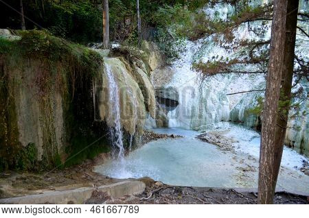 Water Flowing Into A Murky Milky Geothermal Natural Hot Spring In Italy.