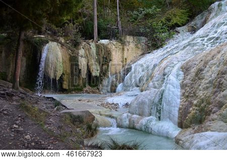 Water Flowing Into A Geothermal Natural Hot Spring In A Wooded Area In Italy.