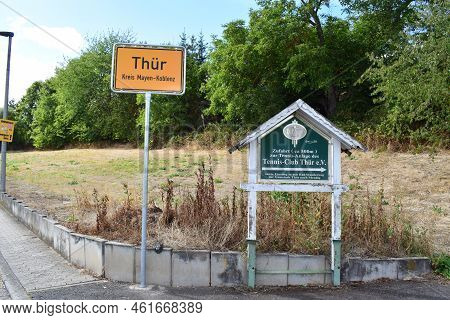 Thür, Germany - 09 08 2022: Village Sign Of Thür With A Tennis Club Sign And Brewery Sponsorship