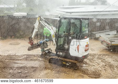Fischbach, Germany - September 7, 2022: Garden Worker In The Small Digger Continues To Work Even In 
