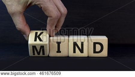 Have A Kind Mind. Businessman Turnsa Wooden Cube And Changes The Word Kind To Mind On A Beautiful Gr