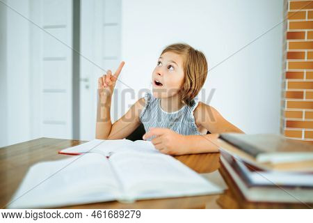 Front View Looking Up Diligent Girl Child Raise Finger Up At Desk Do Homework Had An Insight Everyth