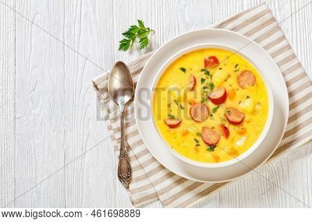Kartoffelsuppe, German Potato Soup With Sausages, Bratwurst In White Bowl On White Wooden Table, Hor