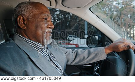 Elderly African American Businessman Driving Automobile On Roadway Experienced Confident Driver Care