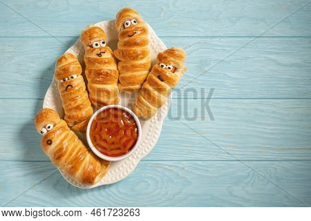Fun Food For Kids. Mummy Sausages Scary Halloween Party Food Decoration Wrapped In Dough With A Bowl