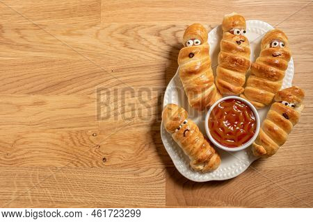 Fun Food For Kids. Mummy Sausages Scary Halloween Party Food Decoration Wrapped In Dough With A Bowl