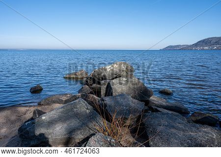Boulders As A Part Of A Wave Breaker In A Lake. Picture From Lake Vattern, Sweden. Blue Water And Sk