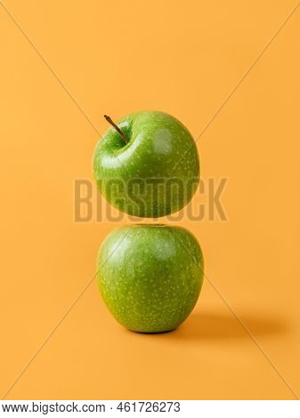 Two Fresh Green Apples Against Yellow Background. Organic Ingredient For Weight Loss Slimming Diet. 