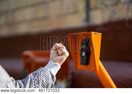 The Concept Of Senseless Aggression And Threat. The Man Threatens The Intercom With His Fist.