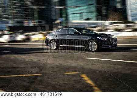 Genesis G80 Car Rides On The City Road. Premium Sedan Car Rushes Along The Street On High Speed. Bla