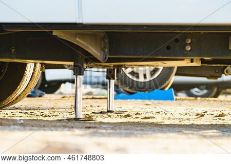 Auto Leveling System For Camper. Hydraulic Steady Leg In Use. Blue Leveler Ramp Chock Block For Rv I