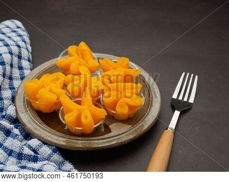 Pinched Gold Egg Yolks Or Khanom Thong Yip In The Thai Language Are Placed On A Plate With Cutlery A