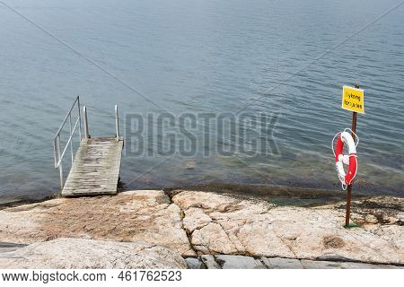 Marstrand, Sweden August 18, 2022: Small Pier With Lifebuoy By The Coastline Near Marstrand