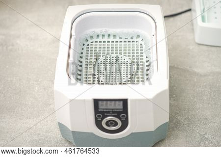Ultrasonic Tools Cleaner. Machine For Disinfection Of Tweezers Tools Before The Depilation Procedure