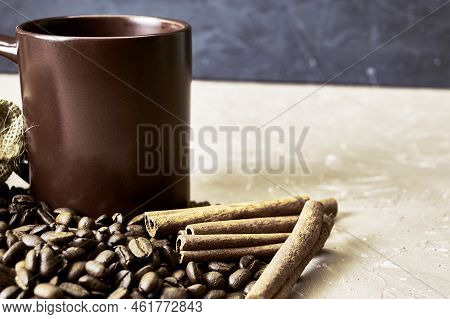 Coffee Beans Spilled Out Of A Canvas Bag Of Cinnamon And A Coffee Mug Onto A Table With A Place Of C
