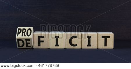 Proficit Or Deficit Symbol. Turned Wooden Cubes And Changed The Concept Word Deficit To Proficit. Be