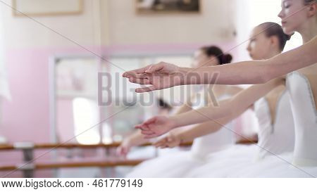 In Ballet Hall, Young Ballerinas Perform Allonge, Moving Hands Elegantly Up And Down, Close-up