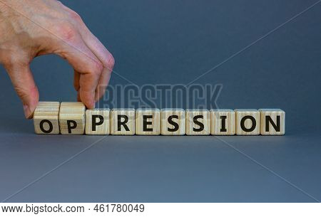 Pression To Oppression Symbol. Businessman Turns Wooden Cubes, Changes The Word Pression To Oppressi