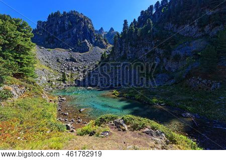 Green Colors Of Leama Lake In Its Small Valley