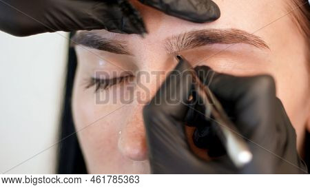 Beauty Saloon. Close-up, Hands Of The Cosmetician In Black Rubber Gloves Hold Tweezers And Pull Out 