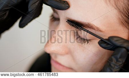 Beauty Saloon. Close-up, Hands Of The Cosmetician In Black Rubber Gloves Keep A Special Brush And Co