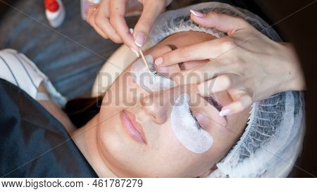 Beauty Saloon. Close-up, Procedure For Eyelash Extension. The Master Wipes The Eyelashes To The Clie