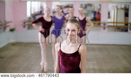 Portrait Of A Young Girl Ballet Dancer In A Lilac Ballet Leotard, Smiling, Gracefully Performing A B