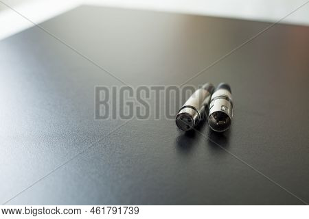 Xlr Audio Cable On Top Of A Black Table. Connections On Display. Xlr Cable Concept. Audio Concept.