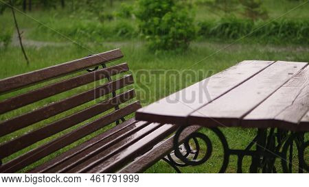 Empty Table And The Bench Are Drenched, Wet Under Rain, On The Playground, In The Yard. A Heavy Rain
