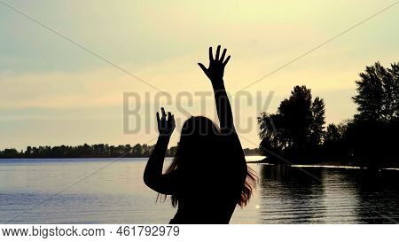 Silhouette Of The Carefree Woman Dancing At The Beach During Beautiful Sunrise. Vacation Vitality He