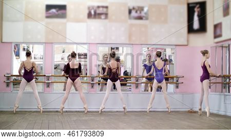In Ballet Hall, Young Ballerinas In Purple Leotards Perform Pas Eshappe, Going Up, Standing On Toes 