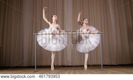 Ballet Rehearsal, In Old Theater Hall. Young Ballerinas In White Ballet Skirts, Tutus, Are Engaged A