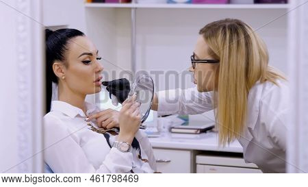 Clinic, Cosmetology Room, The Doctor Shows The Patient A Lip Zone For Injection Of Hyaluronic Acid, 