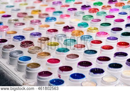 Vibrant Mineral Eyeshadow In Plastic Cosmetic Jars In Row On Counter For Sale In Cosmetics Shop, Tra