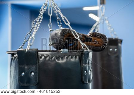 Big Punching Bags Boxing Gloves Close-up. Punching Bags In The Gym.