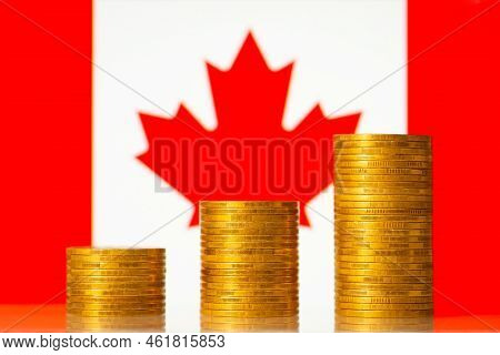 Coins Stacks Against Flag Of Canada. Financial Development Of The Country Concept