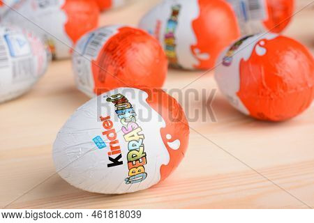 Ukraine, Kyiv - December 25, 2018: Close Up Photo Of Kinder Surprise Egg On A Wooden Table. Chocolat