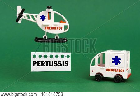 Medical Concept. On A Green Surface, An Ambulance Car And A Helicopter With A Sign - Pertussis