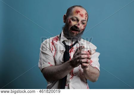 Dangerous Zombie Looking At Cup Of Coffee, Wanting To Dirnk Beverage And Being Aggressive In Studio.