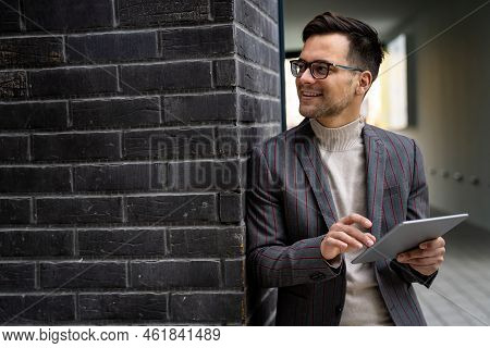 Successful Happy Business Man Working On Digital Tablet In Urban Background