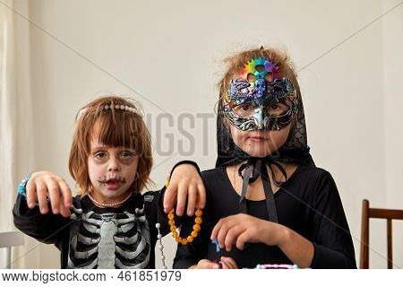 Kids In Halloween Costumes On White Wall Background