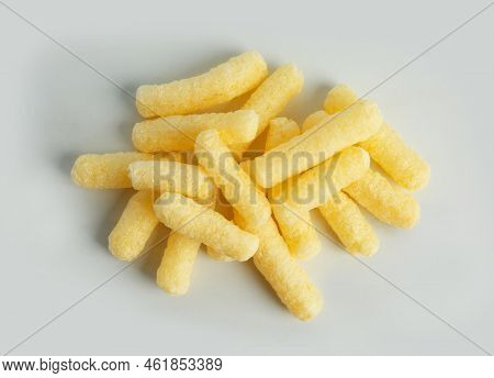 Pile Of Delicious Crispy Corn Sticks On White Background, Flat Lay