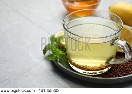 Cup Of Aromatic Buckwheat Tea, Mint, Honey And Granules On Light Grey Marble Table, Closeup. Space F