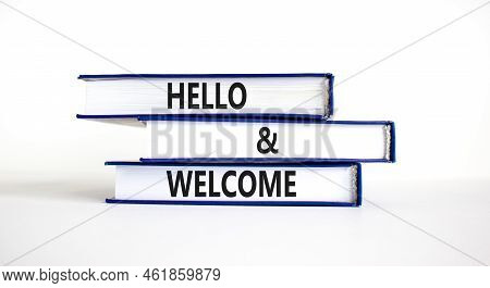 Hello And Welcome Symbol. Concept Words Hello And Welcome On Books. Beautiful White Table White Back