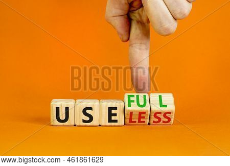 Useful Or Useless Symbol. Concept Words Useful Or Useless On Wooden Cubes. Businessman Hand. Beautif