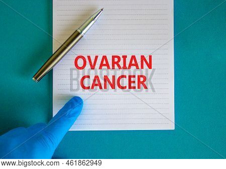 Ovarian Cancer Symbol. White Note With Words Ovarian Cancer, Beautiful Blue Background, Doctor Hand 