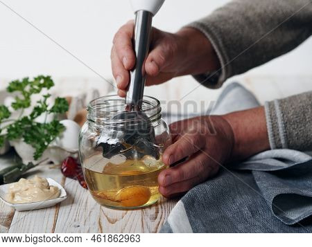 The Stage Of Making Homemade Mayonnaise From Natural Healthy Ingredients.an Elderly Woman Prepares H